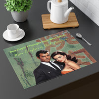 A placemat with a retro romance-novel-inspired illustration of a stylish retro couple set against a weathered green wall with peeling texture and faded red marks. The man stands in a sleek black suit; the woman wears a strapless orange dress with vintage curls and bold lipstick. Pale green text above reads, “red flags? i thought they were spices.” Script text beneath reads, “More Chapters of Bad Decisions,” blending humor, romance, and self-aware bookish sarcasm. The placemat is part of a table display.