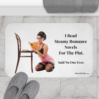 The bath mat is displayed next to a tub with a pair of gray knit slippers.

