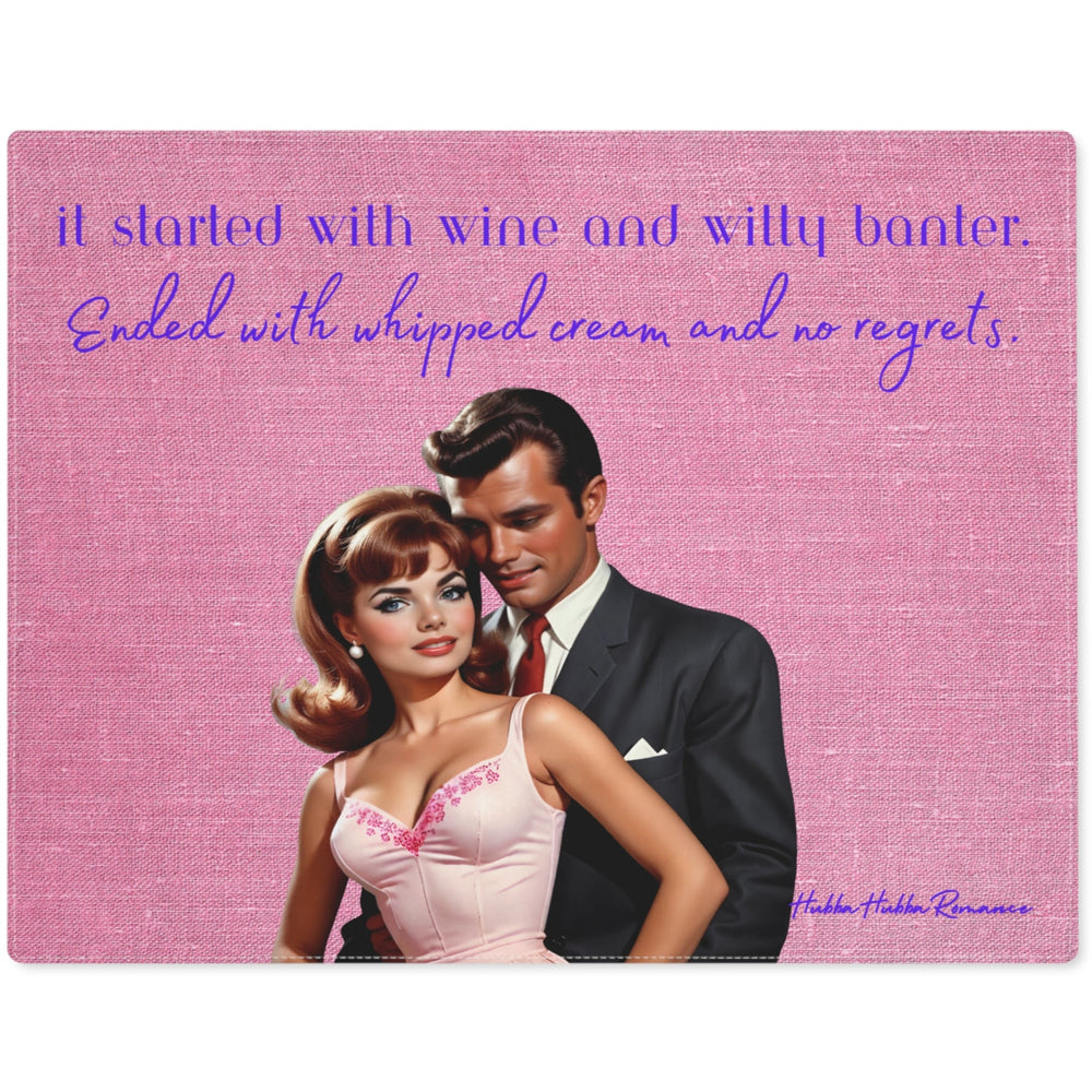 An illustrated retro-style couple stands against a textured pink background. The woman has shoulder-length auburn hair styled in vintage waves and wears a pale pink dress with delicate embroidery at the neckline. She smiles sweetly while the dark-haired man, dressed in a black suit and white shirt, stands closely behind her with a charming, slightly mischievous expression. Above them, playful text reads: "It started with wine and witty banter. Ended with whipped cream and no regrets." 