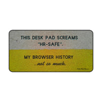 A horizontal desk mat with a textured background of muted yellow and gray tones. The top text reads “THIS DESK MAT SCREAMS ‘HR-SAFE’.” Below it, smaller text says, “MY BROWSER HISTORY ...not so much.” All text is in black and capitalized except the final line, which is lowercase and cursive. This is the large size.