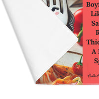The placemat is folded over at the left corner to show the white cotton backing.
