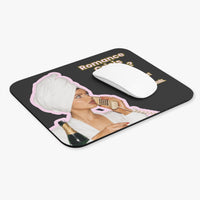A rectangular black mousepad with rounded corners, featuring a retro-style graphic of a woman in a white robe and turban wrapping a phone, with the text 'Romance Crisiis Hotline. I'd like to report a shortage of book boyfriends.