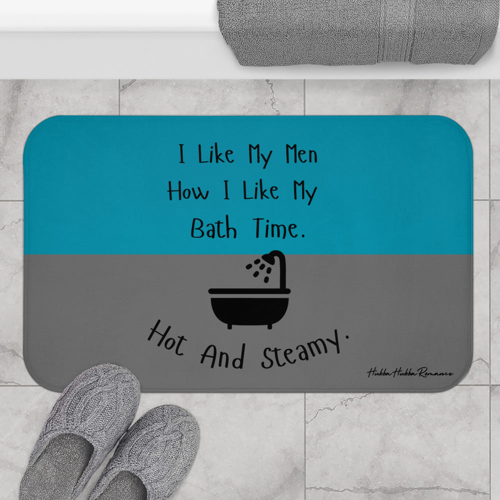 The bath mat is displayed next to a tub with a pair of slippers for size context.
