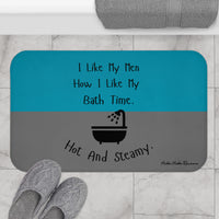 The bath mat is displayed next to a tub with a pair of slippers for size context.
