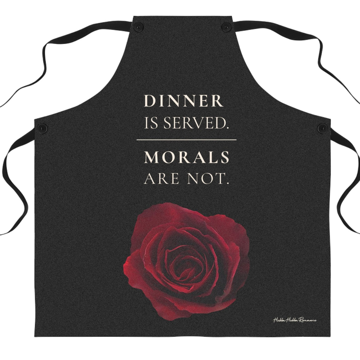 A black apron with a red rose graphic and the large cream colored text above it that reads 'DINNER IS SERVED. MORALS ARE NOT.