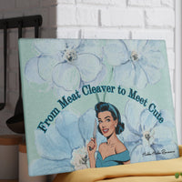 The cutting board is beautiful enough to be displayed upright in the kitchen as a decorative piece. The cutting board is shown placed against a white brick wall.

