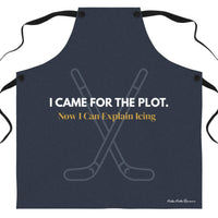 A dark navy blue apron with black neck and waist ties, featuring a graphic of crossed hockey sticks and the text 'I CAME FOR THE PLOT in white text. Now I Can Explain Icing' in gold, on a plain white background.