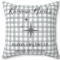 A 20-inch pillow featuring a gray and white gingham background with elegant script text that reads: "Romance Novels." Below, in a playful handwritten-style font, the phrase "modern fairy tales for grown ass women" is written. To the left of the text, there are three gray starbursts, adding a touch of vintage charm. The overall design is minimalist yet bold, appealing to romance readers who embrace their love for modern-day fairy tales.