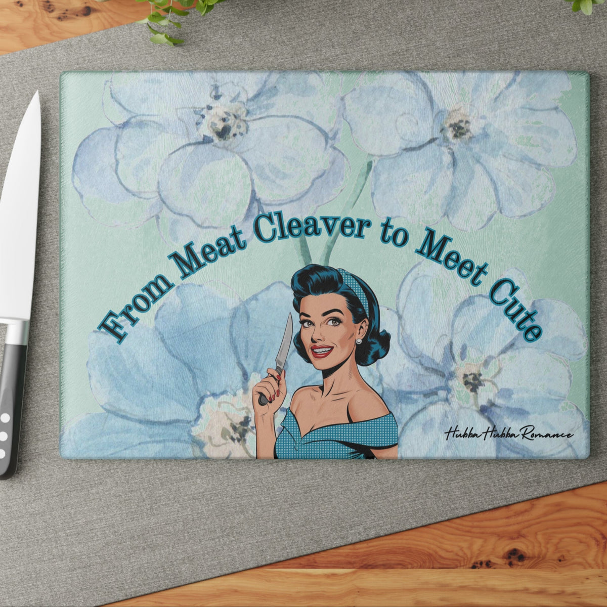 This image shows the cutting board displayed on the table with a knife placed beside it in anticipation of using the board to cut something.

