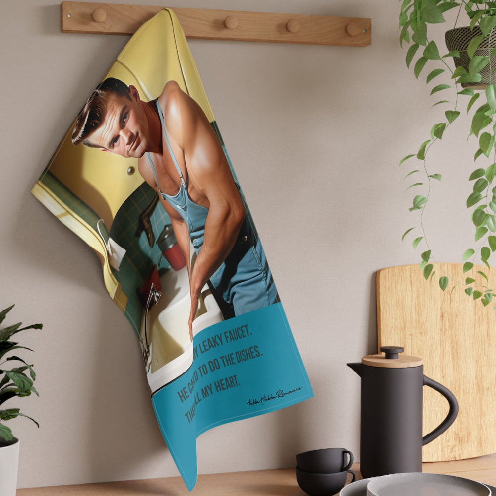 The towel is displayed on a wall hook in a kitchen setting.
