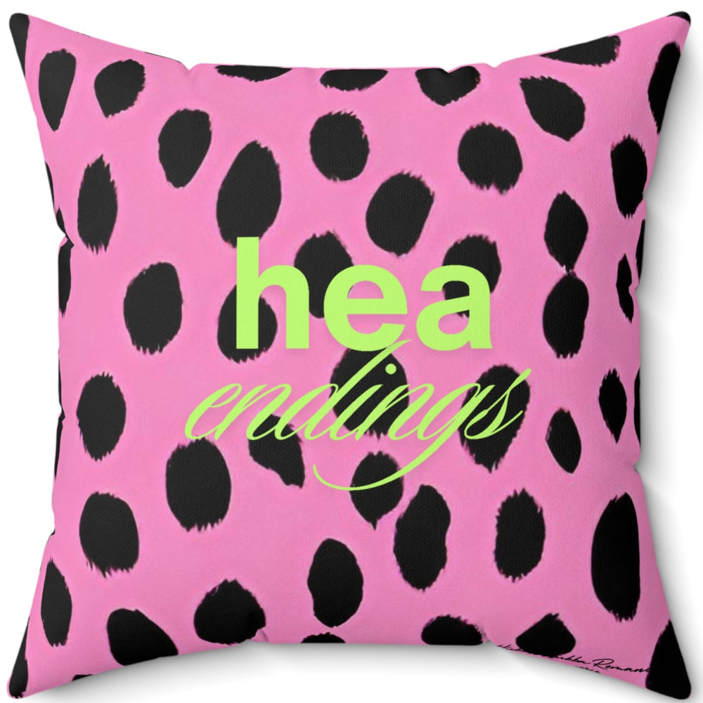 The back side of the pillow has a similar– but not identical - bold pink and black leopard print background with the words “HEA” stacked over the word “Endings” in reference to the classic happily-ever-after trope in romance novels.  