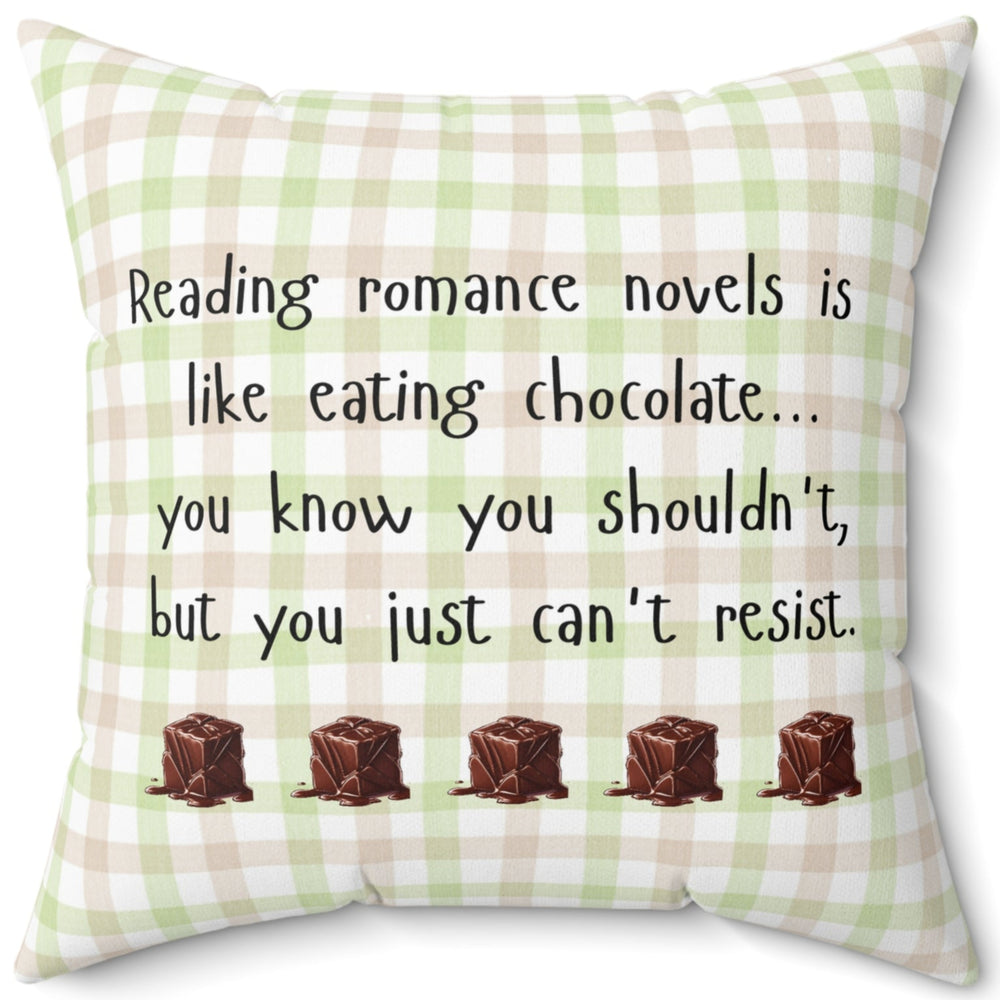 This 20-inch pillow features a white, light pink, and light green plaid background with black handwritten text that reads: "Reading romance novels is like eating chocolate… you know you shouldn’t, but you just can’t resist." Below the text, five illustrated chocolate pieces with a glossy, melting effect are lined up in a row. The overall design has a cozy, playful feel, combining a love for romance books with the indulgence of chocolate.