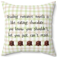 This 20-inch pillow features a white, light pink, and light green plaid background with black handwritten text that reads: "Reading romance novels is like eating chocolate… you know you shouldn’t, but you just can’t resist." Below the text, five illustrated chocolate pieces with a glossy, melting effect are lined up in a row. The overall design has a cozy, playful feel, combining a love for romance books with the indulgence of chocolate.