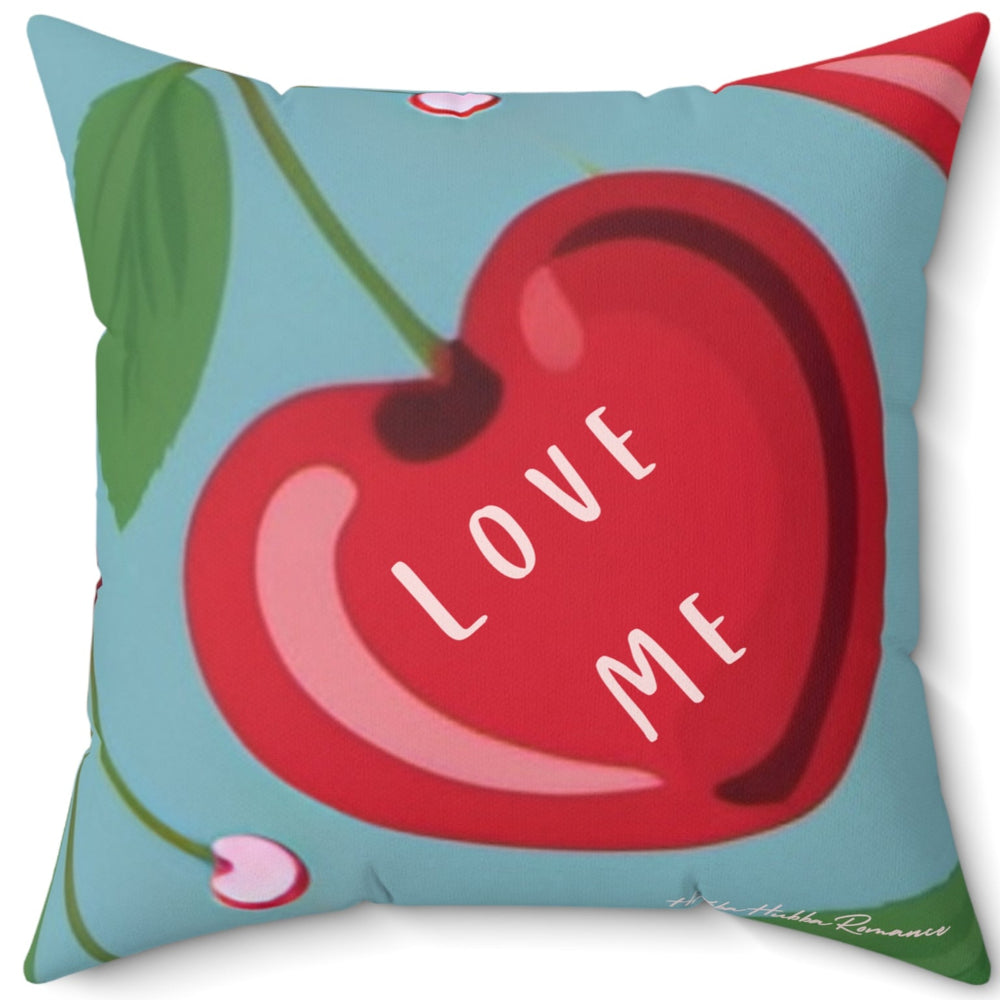 The back side of the pillow features the same background color as the front side but only a single large cherry with the words "Love Me".

