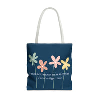 A navy blue canvas tote bag with white shoulder straps, featuring a graphic of four colorful flowers (green, orange, pink, yellow) and the quote 'IF BOOK BOYFRIENDS WERE FLOWERS. I'd need a bigger vase.