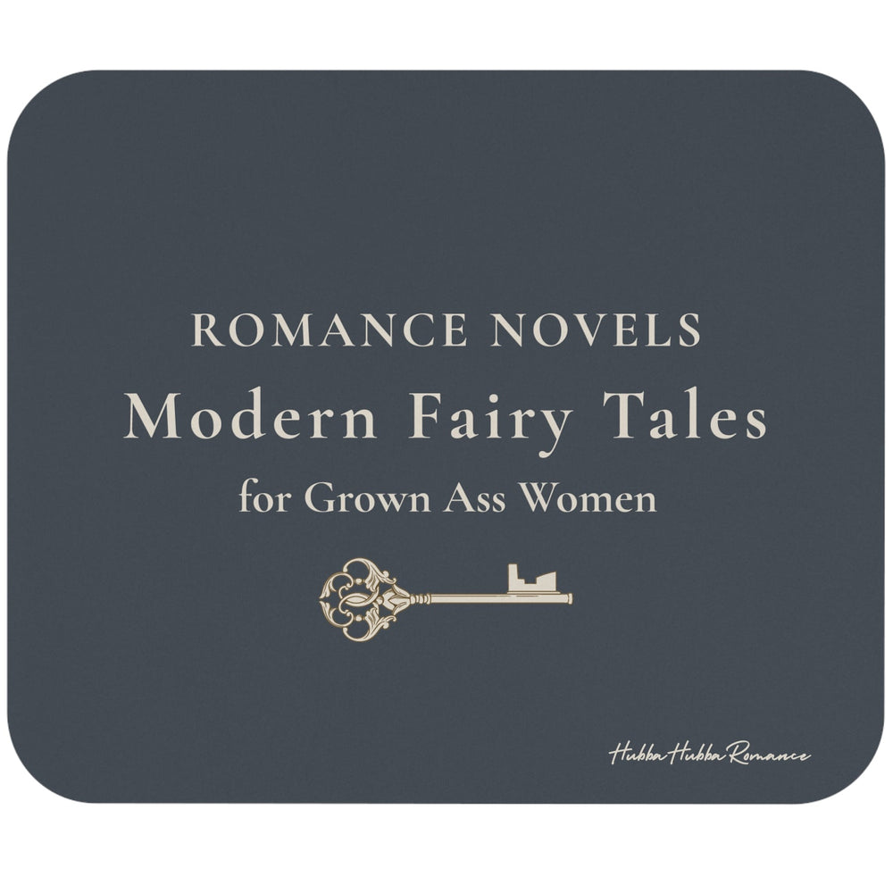 A rectangular mouse pad with rounded corners, shown on a plain white background. The cover is dark charcoal gray with cream text reading 'ROMANCE NOVELS Modern Fairy Tales for Grown Ass Women' and a small decorative key illustration.