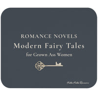A rectangular mouse pad with rounded corners, shown on a plain white background. The cover is dark charcoal gray with cream text reading 'ROMANCE NOVELS Modern Fairy Tales for Grown Ass Women' and a small decorative key illustration.