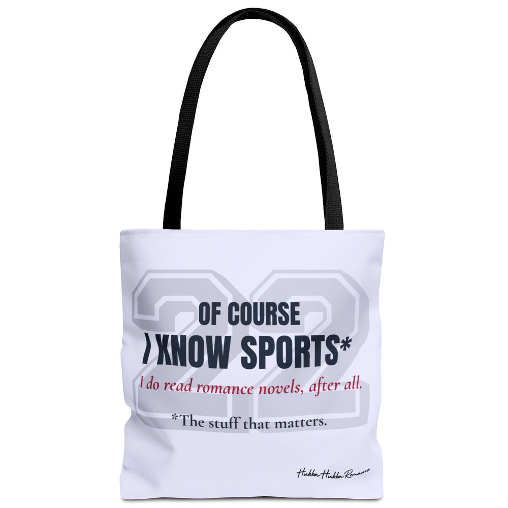 Pale blue romance reader tote bag with a large pale gray varsity-style 22 and dark navy text reading “Of Course I Know Sports*.” Red script reads “I do read romance novels, after all.” Small dark text reads “*The stuff that matters.” Black handles.