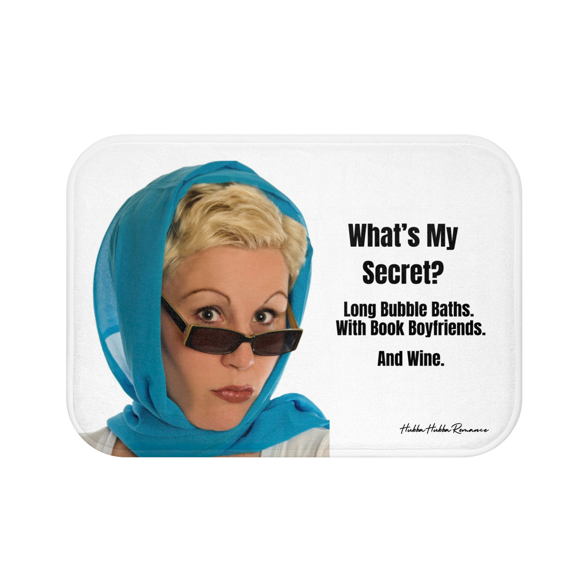 This bath mat features a retro-style image of a woman with short blond hair, wearing a turquoise headscarf and sunglasses, giving a dramatic stare. To the right of her, bold black text reads: “How Do I Relax? Long Bubble Baths With Book Boyfriends. And Wine.” The background is white, and the design blends humor with a glamorous vintage vibe. The mat is soft, absorbent, and ideal for romance readers with a flair for the dramatic.This is the smallerr size.