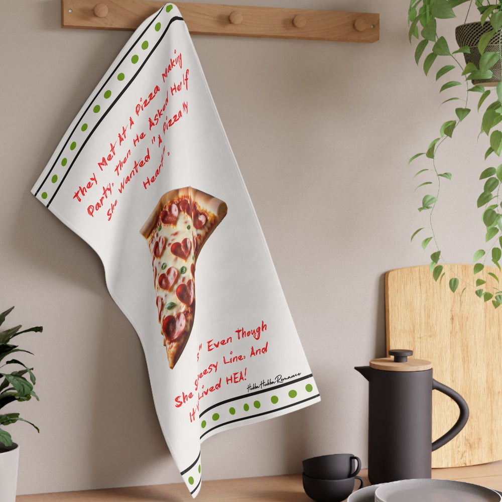 The towel is displayed on a wall hook in a kitchen setting.
