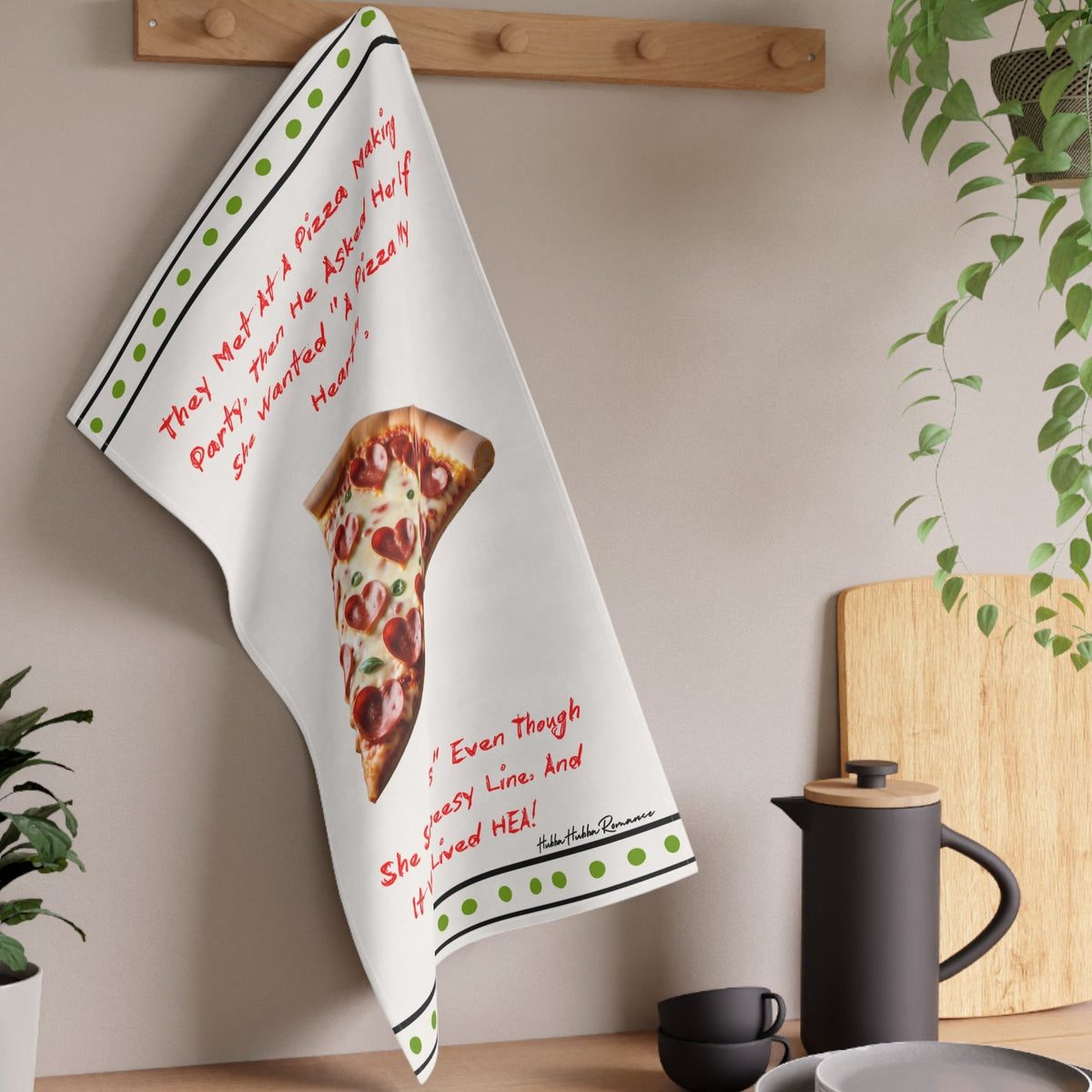 The towel is displayed on a wall hook in a kitchen setting.
