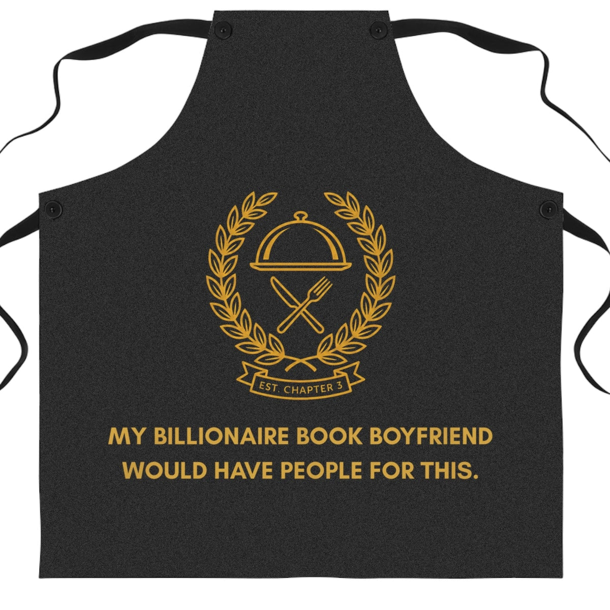 A black bib-style apron with gold printed graphics and text on the front, shown flat against a plain white background. The design features a gold chef's cloche and crossed utensils emblem with the text 'Est CHAPTER 3' inside a laurel wreath, and the phrase 'MY BILLIONAIRE BOOK BOYFRIEND WOULD HAVE PEOPLE FOR THIS.