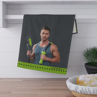The towel is displayed by folding it over a towel bar underneath a shelf.