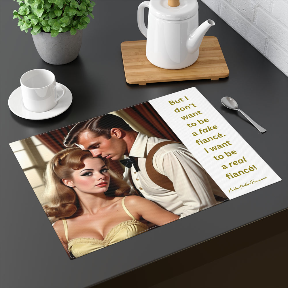 The placemat is displayed on a table with a cup and saucer, a teapot, a plant, and a spoon for context.

