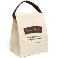 This lunch bag features a plain canvas background with two prominent text sections. At the top, a stylized brown label with pink stitching contains the words “Romance Novels” in a cursive pink font. Below the label, bold pink and brown text reads: “Nourishment For Spicy Women.” The design resembles a vintage food label with a modern, sassy twist. The bag is made of durable canvas with a roll-top closure and a carrying strap, perfect for everyday use and displayed upright in this image.