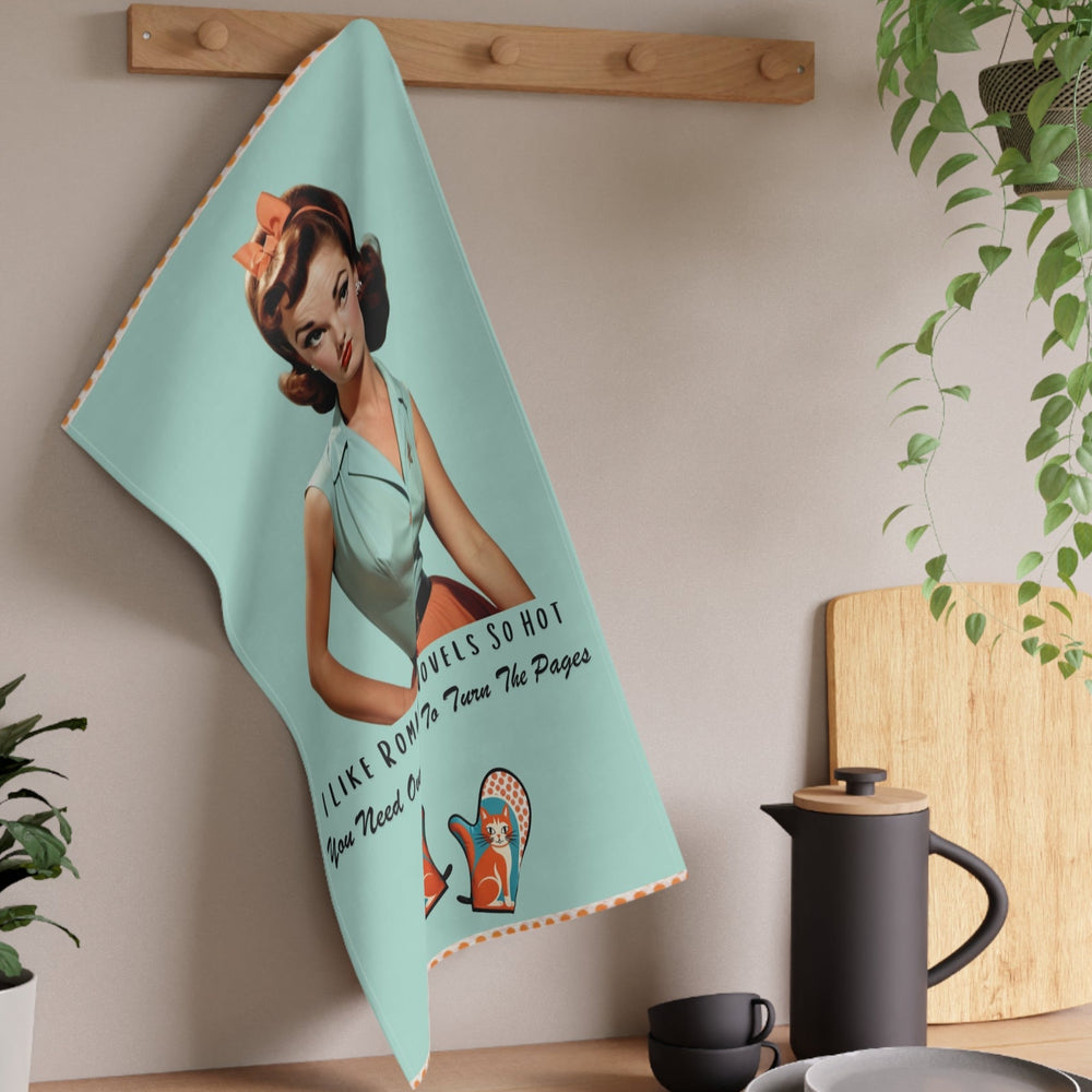 The towel is displayed by hanging it off a peg in a kitchen setting.