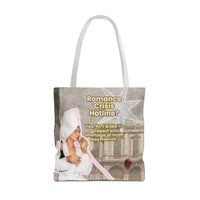 A tote bag with white shoulder straps, featuring a printed graphic collage with the text 'Romance Crisis Hotline?' and an illustration of a woman in a white robe and towel, holding a bottle of champaign and talking on a phone next to a classical building. Totally silly but fun.