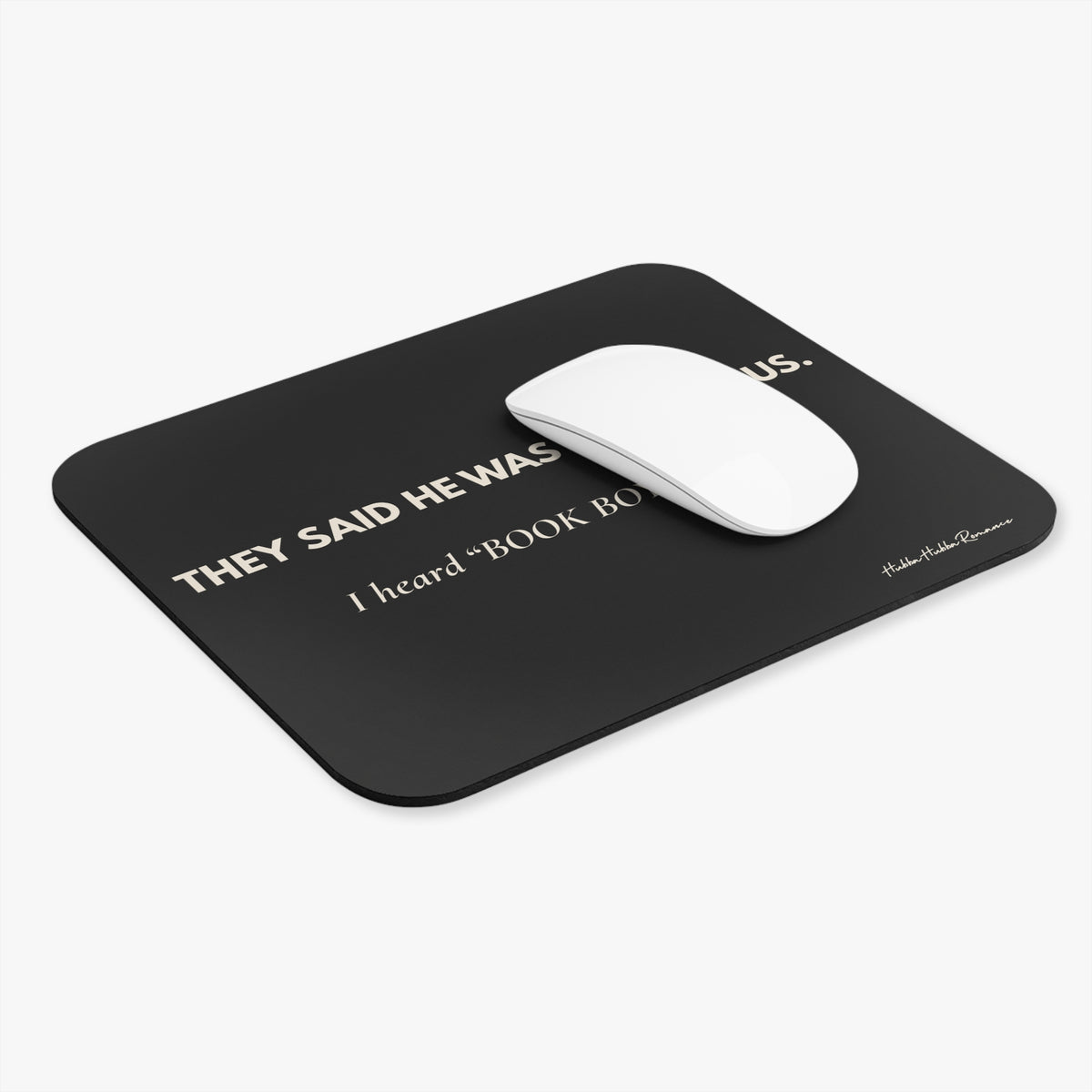 Black mouse pad with cream text and a white mouse on a white background
