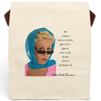 This canvas lunch bag features a retro-inspired image of a blonde woman wearing a bright blue headscarf and sunglasses. She has a bold, confident expression. To the right of her, in a casual black font, the text reads: “My Lunch Philosophy: Why Eat When You Can Read Spicy Romance?” The background is white, and the design channels vintage glamour with a sassy, modern bookish twist. The bag includes a roll-top closure, canvas strap, and durable material for everyday use.