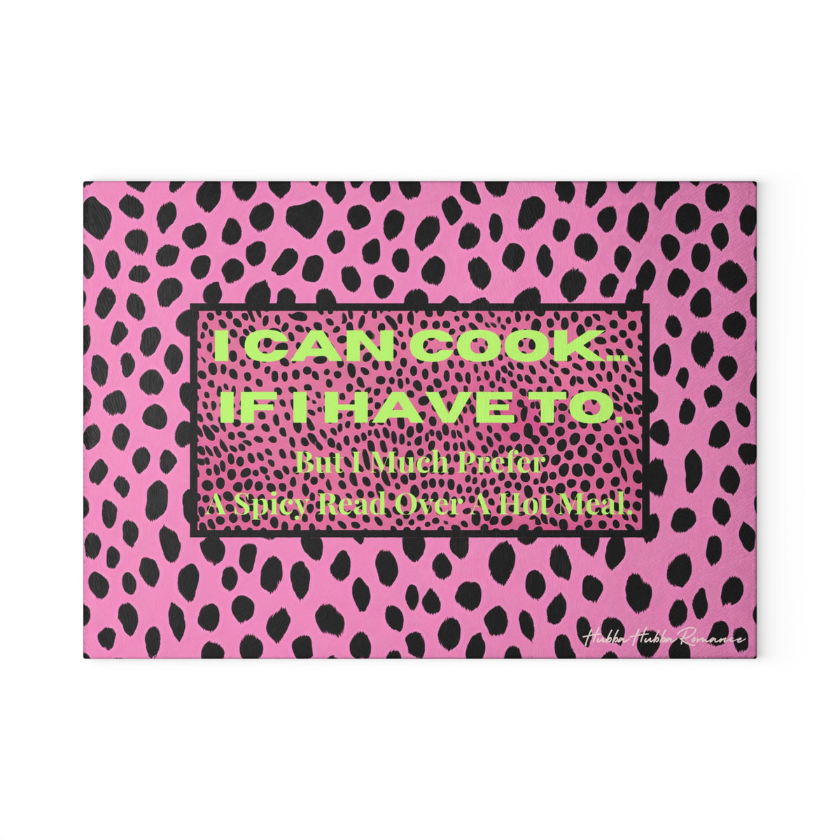 Glass cutting board featuring a hot pink and black leopard print background. Centered on the board is a bold text box that reads: “I CAN COOK—IF I HAVE TO. But I Much Prefer A Spicy Read Over A Hot Meal.” Made from durable, textured tempered glass with non-slip rubber feet for stability. This is the smaller size.