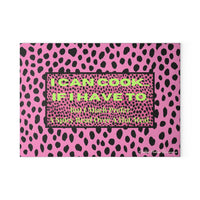 Glass cutting board featuring a hot pink and black leopard print background. Centered on the board is a bold text box that reads: “I CAN COOK—IF I HAVE TO. But I Much Prefer A Spicy Read Over A Hot Meal.” Made from durable, textured tempered glass with non-slip rubber feet for stability. This is the smaller size.