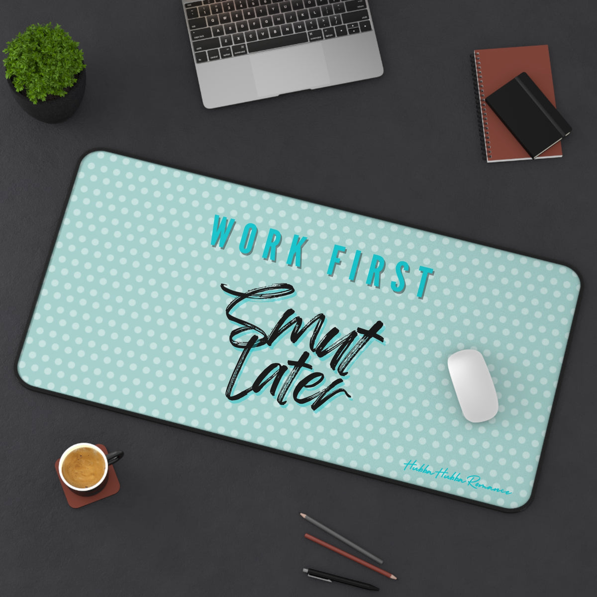 Desk setup with a mouse pad featuring 'Work First, Smut Later' text on a teal background.