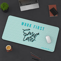 Desk setup with a mouse pad featuring 'Work First, Smut Later' text on a teal background.