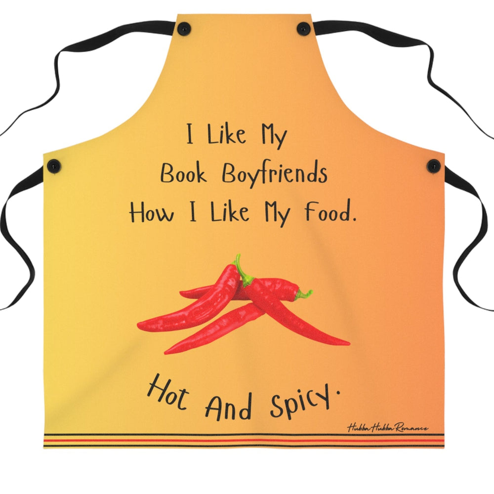 An orangy yellow apron with black straps features the phrase, "I like my book boyfriends how I like my food. Hot and spicy." in black text. Below the text, there is an illustration of three red chili peppers. The bottom of the apron has a decorative striped trim.
