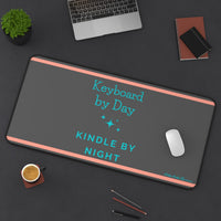 The desk mat is displayed with a laptop nearby and a mouse on it, with assorted office items lying on the desk as well.
