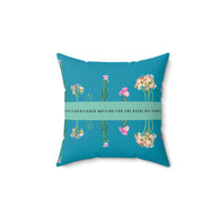 A 14-inch pillow that features an arrangement of delicate wildflowers, some upright and others hanging upside down, against a vibrant teal background. A horizontal light green banner stretches across the center, displaying the phrase "I'm just a wildflower waiting for the right bee to notice." in black text. The design is whimsical and romantic, symbolizing patience, individuality, and the hope of finding the perfect match.