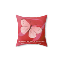A 14-inch pillow featuring a soft pink butterfly with delicate brown markings on its wings, set against a blurred close-up of a pink flower petal. The butterfly has a watercolor-like texture and a graceful appearance. Below the butterfly, pale pink uppercase text reads: "If butterflies had a language, they’d speak romance." The background is a warm, romantic shade of pink, creating a dreamy and whimsical aesthetic.