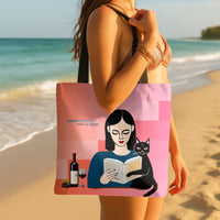 The tote bag is displayed by a woman walking down the beach with the bag slung over her shoulder. 