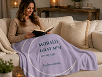 Romance reader wrapped in a lavender sweatshirt blanket featuring the quote "Morally Gray Men Are My Type. Unfortunately." Cozy reading scene inspired by dark romance, fantasy romance, and fictional red flags.
