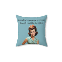 A 14-inch pillow featuring a vintage-inspired illustration of a glamorous 1950s woman with red hair styled in curls, wearing a mint green blouse with orange buttons, an orange skirt, a black belt, and a matching orange bow in her hair. She has bold red lipstick and a skeptical expression. The background is a solid teal color. Above her, black text reads: "If reading romance is wrong, I don’t want to be right."