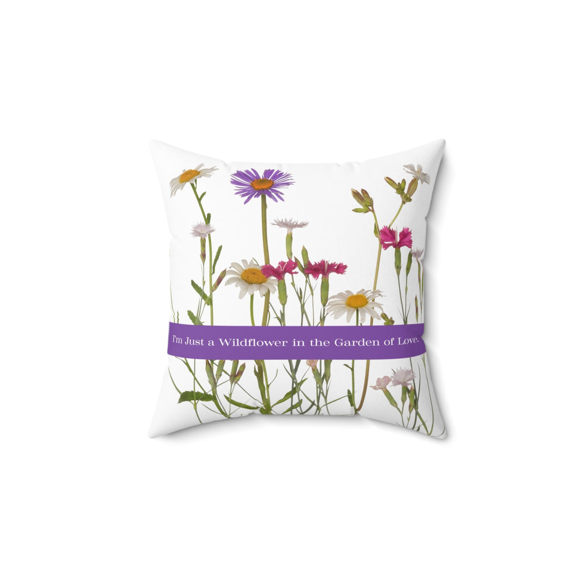 A 14-inch pillow that features a collection of wildflowers, including daisies, pink carnations, and a prominent purple aster, set against a clean white background. A horizontal purple banner stretches across the center, displaying the phrase "I'm Just a Wildflower in the Garden of Love." in white text. The design has a soft, romantic feel, evoking themes of individuality, natural beauty, and love.