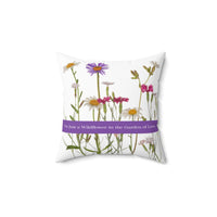 A 14-inch pillow that features a collection of wildflowers, including daisies, pink carnations, and a prominent purple aster, set against a clean white background. A horizontal purple banner stretches across the center, displaying the phrase "I'm Just a Wildflower in the Garden of Love." in white text. The design has a soft, romantic feel, evoking themes of individuality, natural beauty, and love.