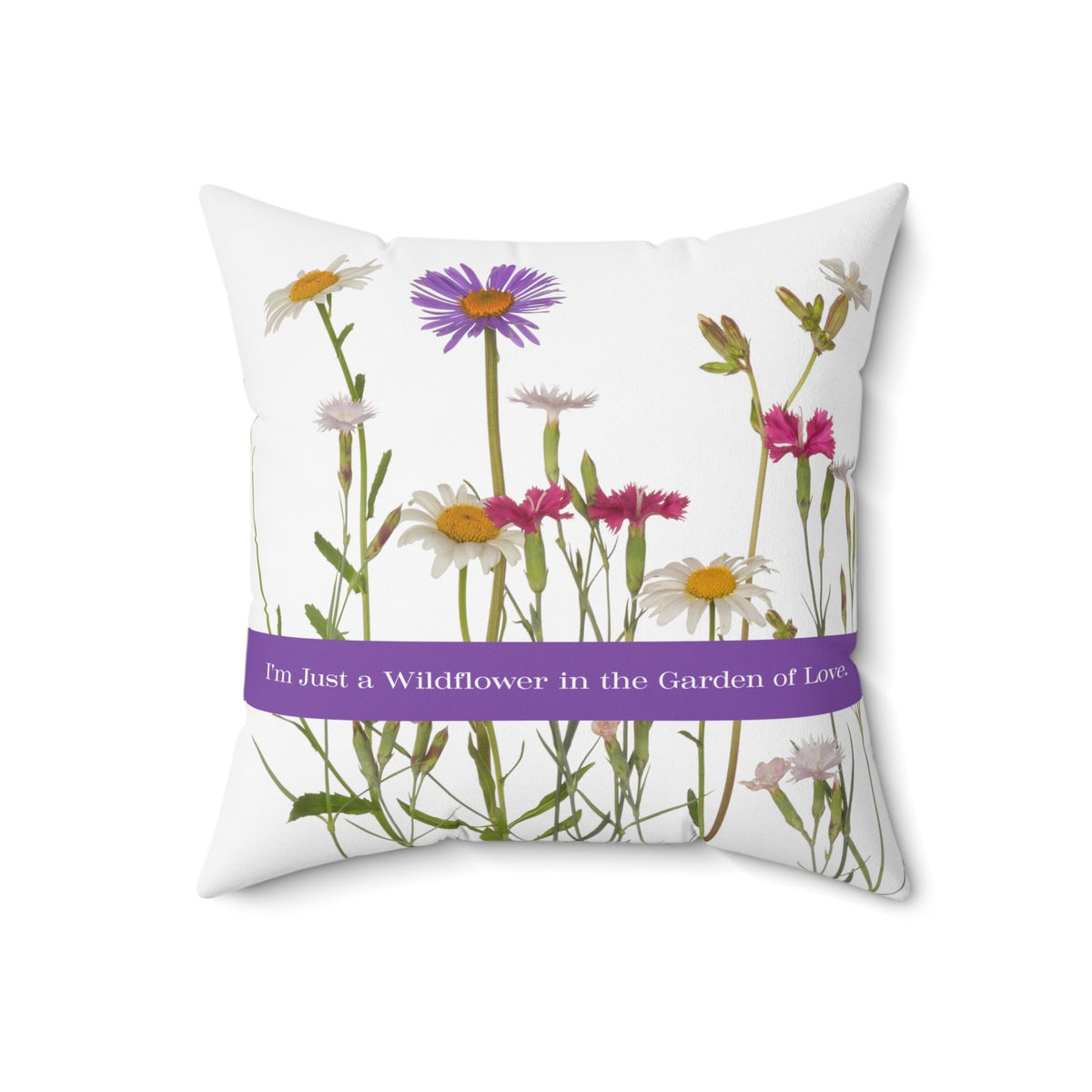 An 18-inch pillow that features a collection of wildflowers, including daisies, pink carnations, and a prominent purple aster, set against a clean white background. A horizontal purple banner stretches across the center, displaying the phrase "I'm Just a Wildflower in the Garden of Love." in white text. The design has a soft, romantic feel, evoking themes of individuality, natural beauty, and love.