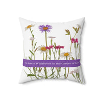 An 18-inch pillow that features a collection of wildflowers, including daisies, pink carnations, and a prominent purple aster, set against a clean white background. A horizontal purple banner stretches across the center, displaying the phrase "I'm Just a Wildflower in the Garden of Love." in white text. The design has a soft, romantic feel, evoking themes of individuality, natural beauty, and love.