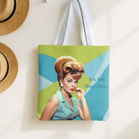 The bag is being displayed by hanging it oon a hook. Straw hats are nearby for decor.