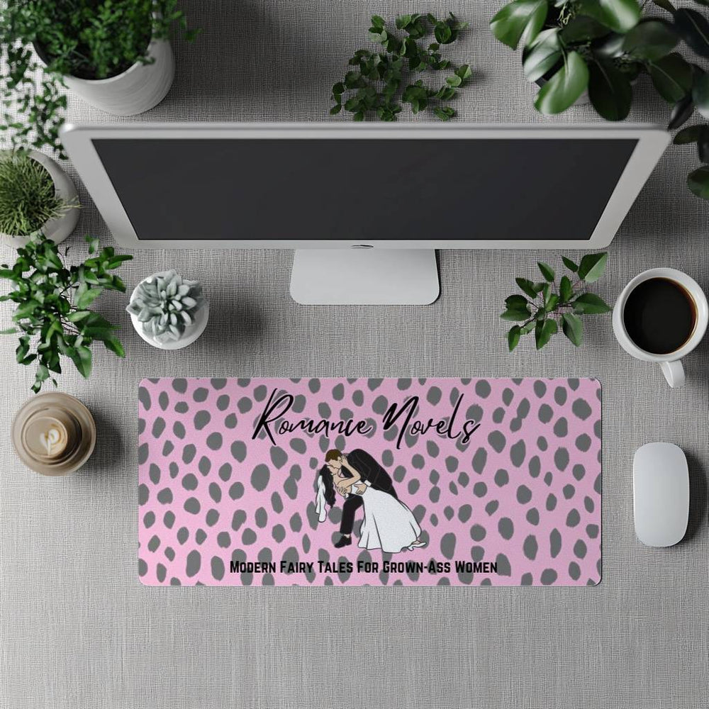 The desk mat is displayed in front of a standing full-size computer screen for use with a separate keyboard.
